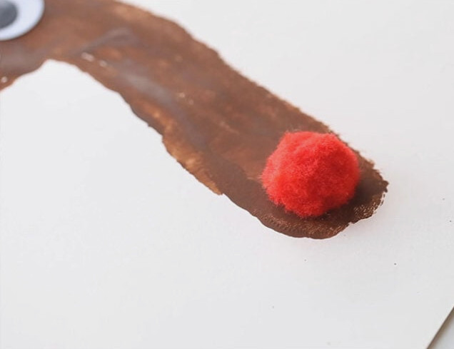 Place Red Pom Pom on Nose