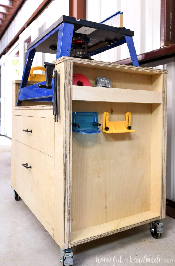 Right side of the plywood router table featuring cubbies and hooks for storing router accessories.