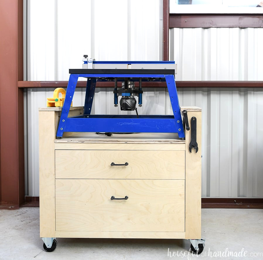 Square photo of the router cart straight on with the router table on top and the accessories hanging in their spots.