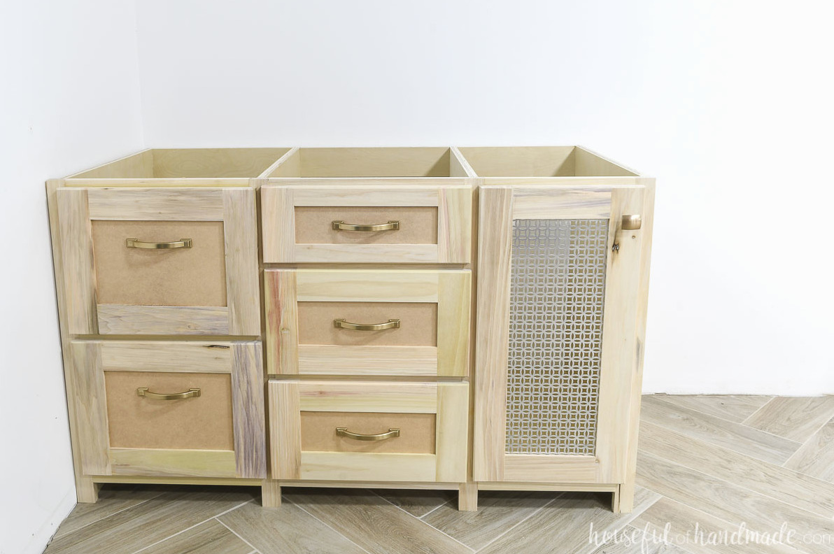 Detailed view of one built-in desk cabinet section with filing drawers and a cabinet designed for a computer stack.