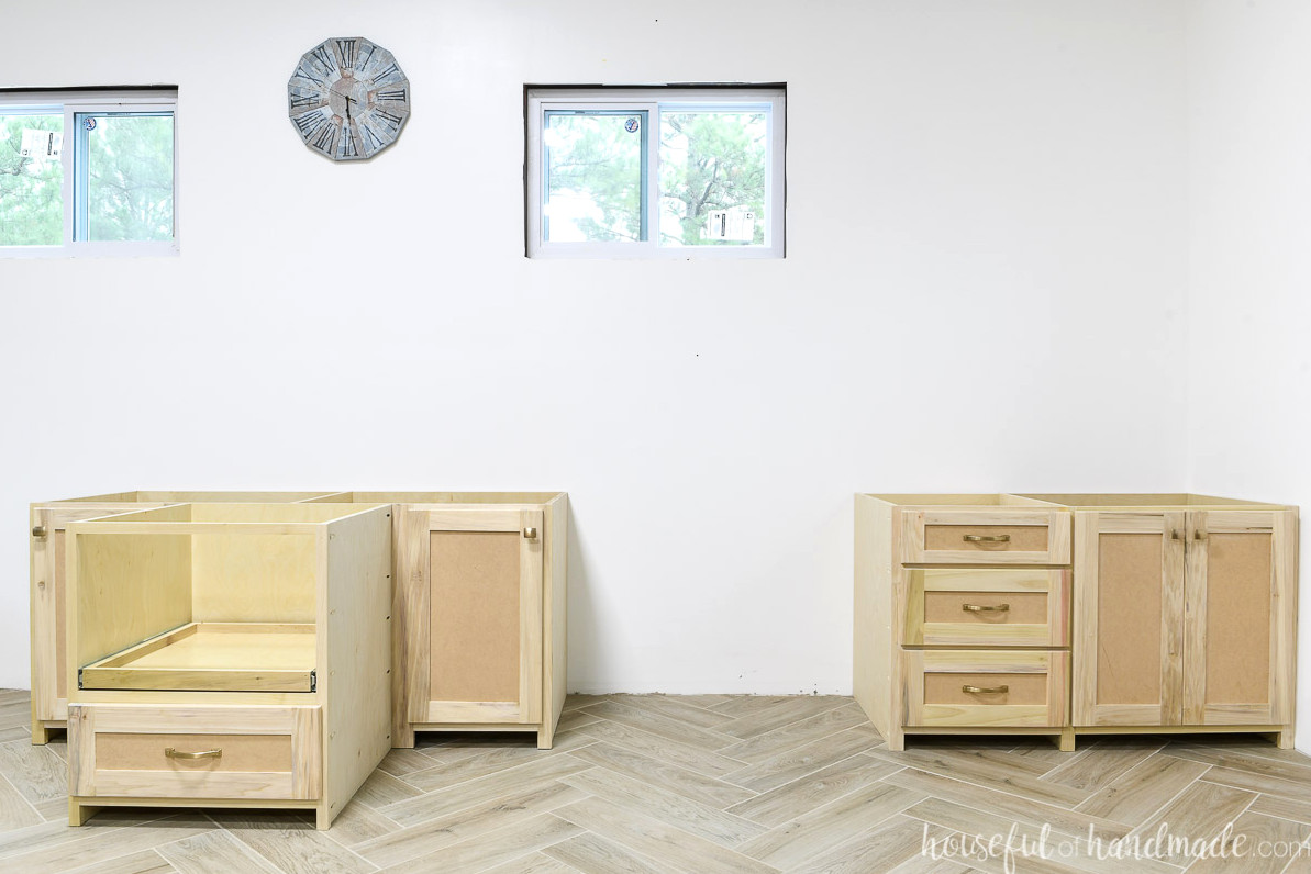 One side of the built-in desk designed for two computers, featuring numerous drawers and storage cabinets.