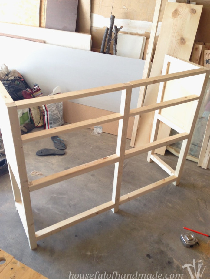 Shelf support pieces attached to the front between the side pieces. 