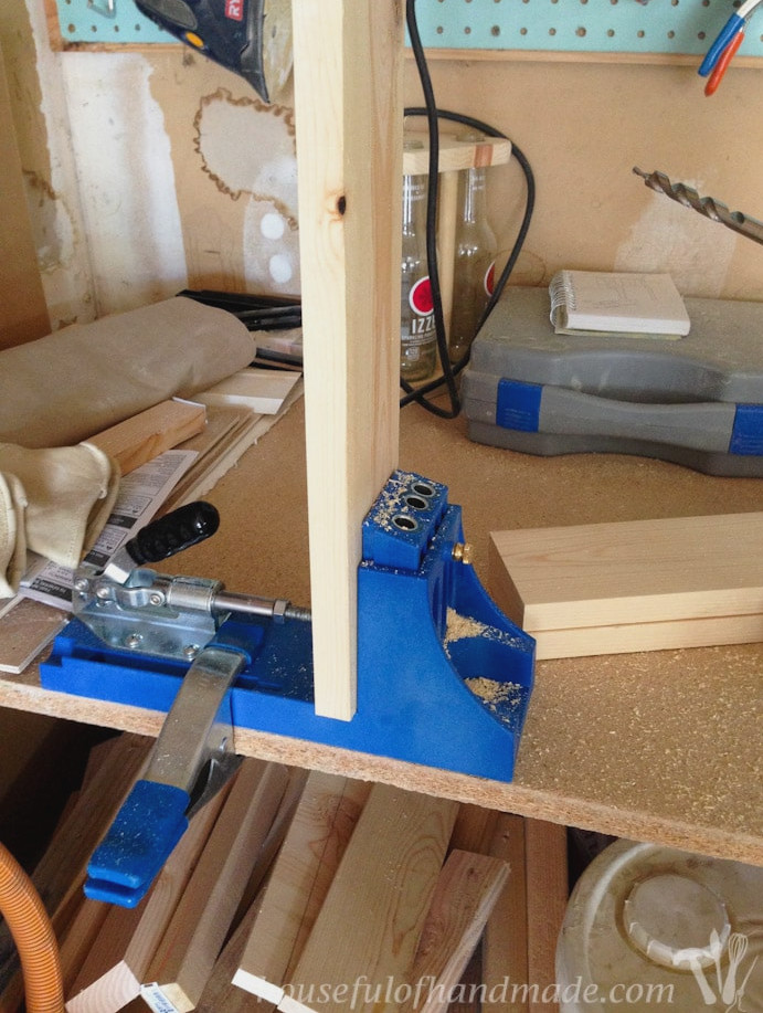 Drilling pocket holes in a 1x4 with a Kreg jig. 