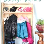 Front view of the fold-down storage shelves in the mudroom with words "Collapsible Storage Shelves" on it.
