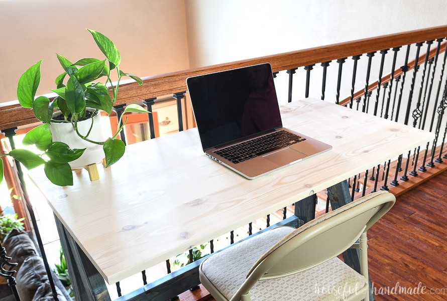 Folding desk surface made from 1x6 boards and finished with white wood stain.