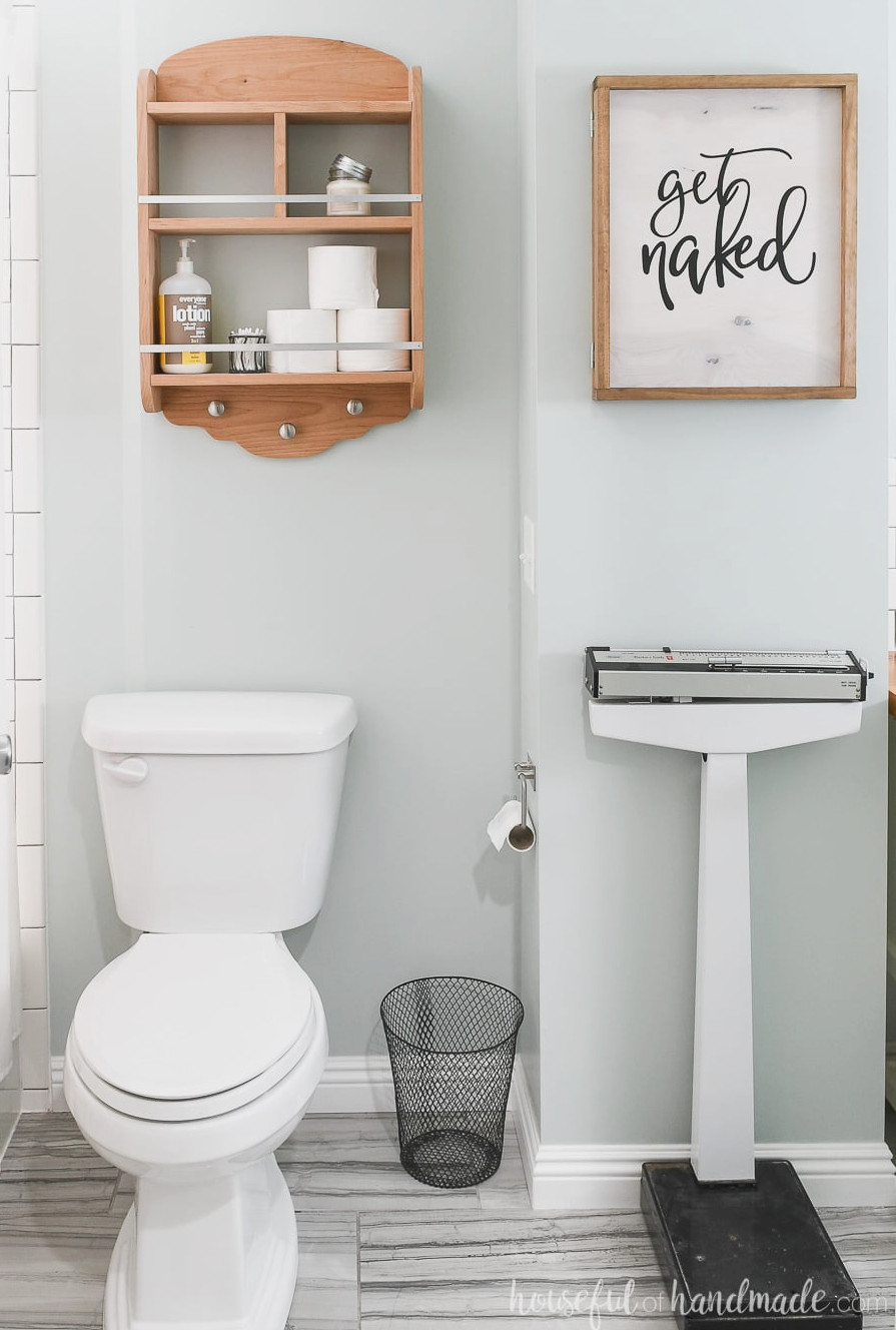 Bathroom featuring a DIY wall jewelry organizer with a wooden sign on the front.