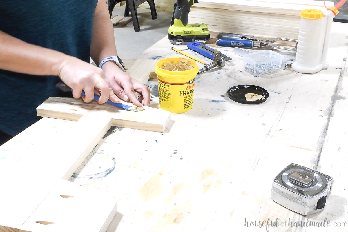 Concealing the pocket holes with wood putty on the rolling cart sides.