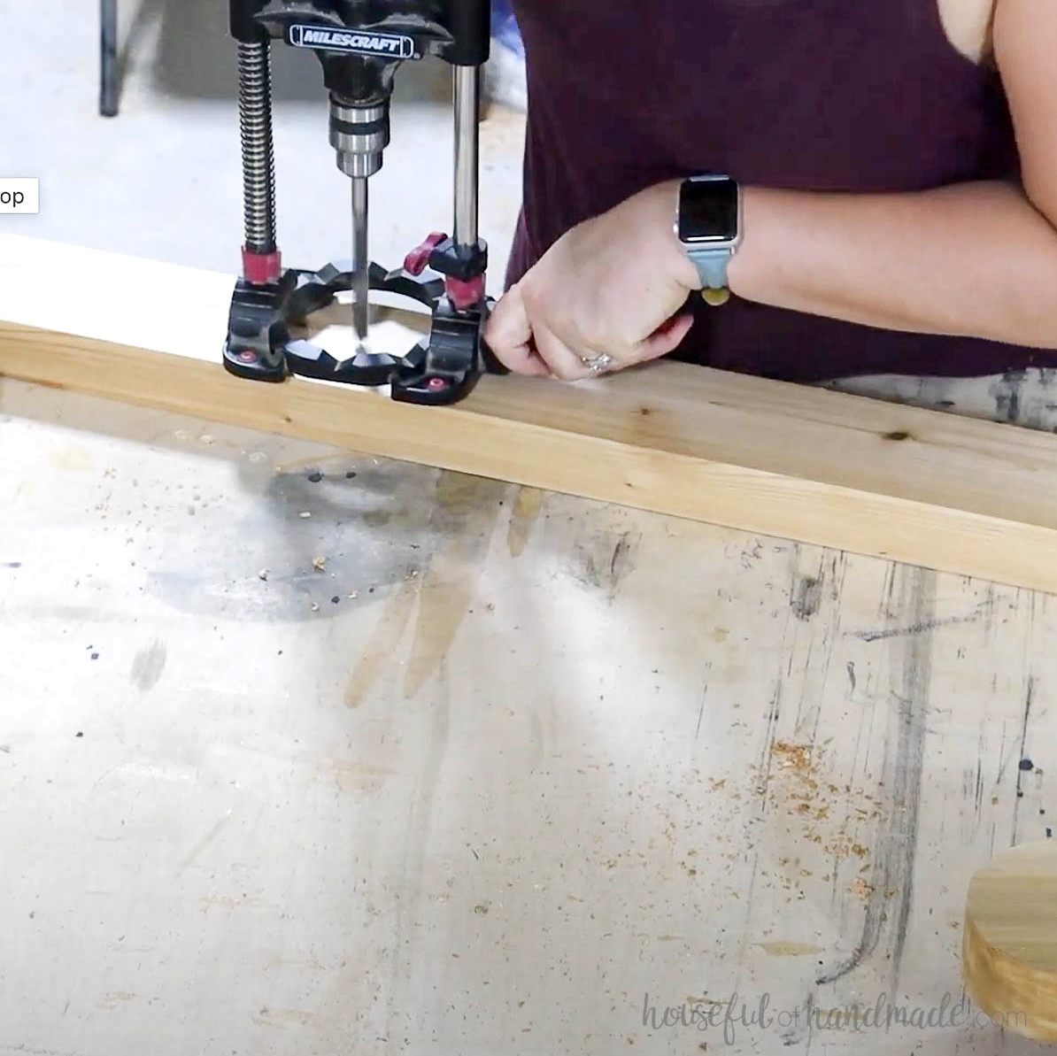 Using a drill guide to make holes for the leg assembly. 