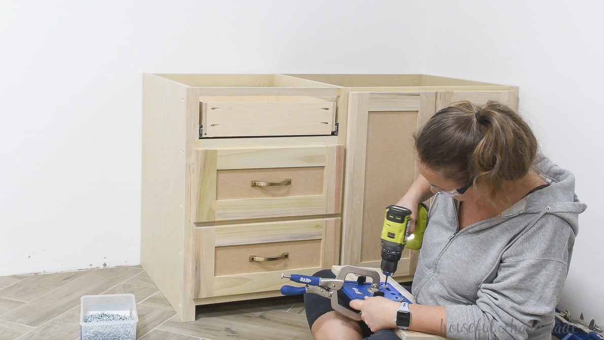 Marking placement for the drawer pulls with the Kreg cabinet hardware jig.