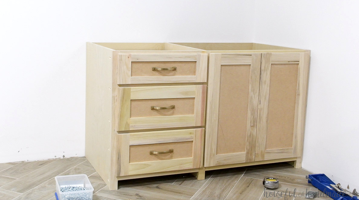 One section of the built in desk cabinets with the drawer fronts attached with pulls.