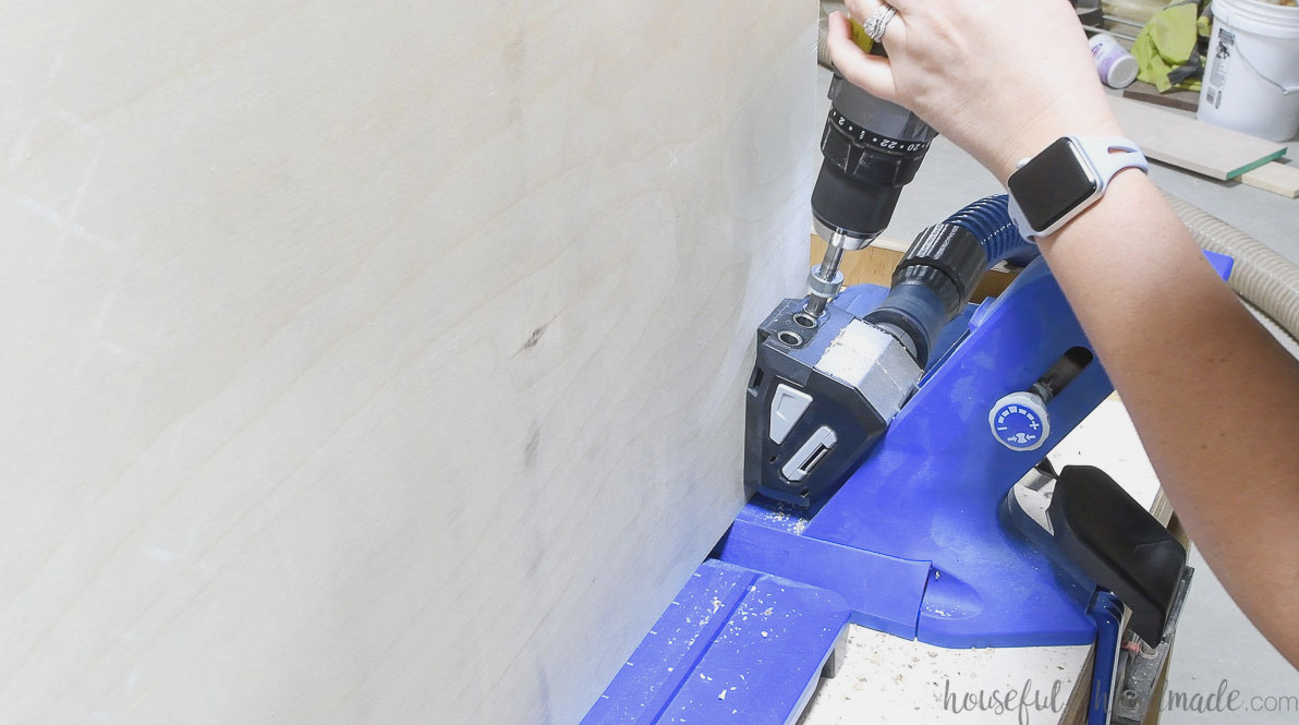 Drilling pocket holes in the cabinet side panels for attachment to the face frame.