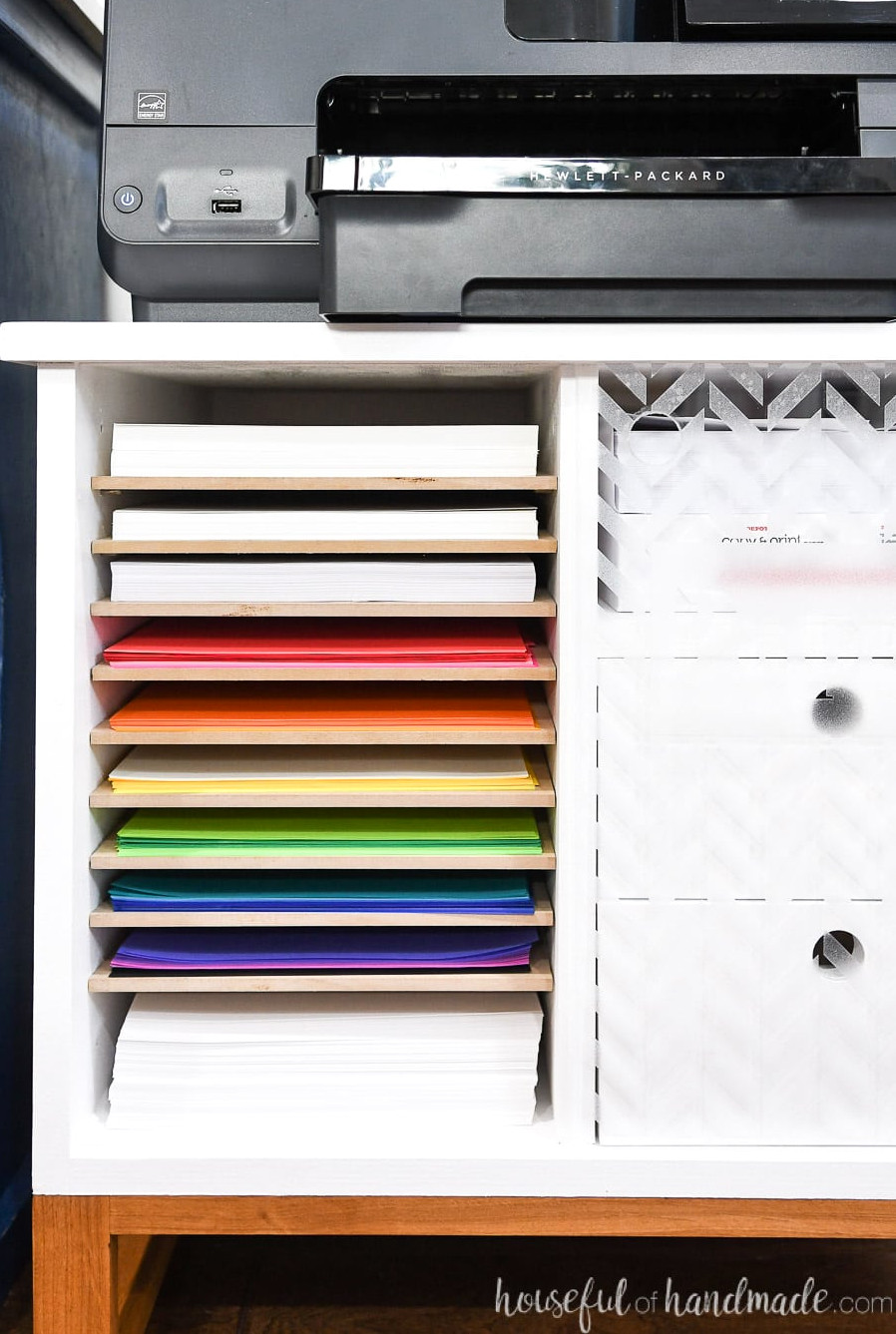 Detailed view of the paper-storage shelves in the printer table.