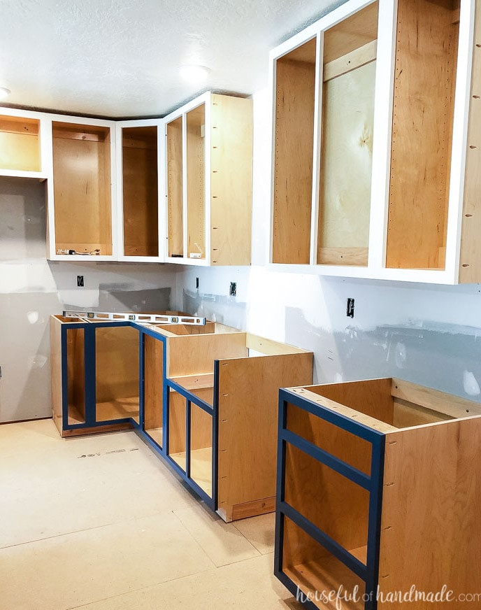 Cabinet boxes installed without doors during the kitchen renovation. The DIY kitchen cabinets were placed on 2x4 bases.