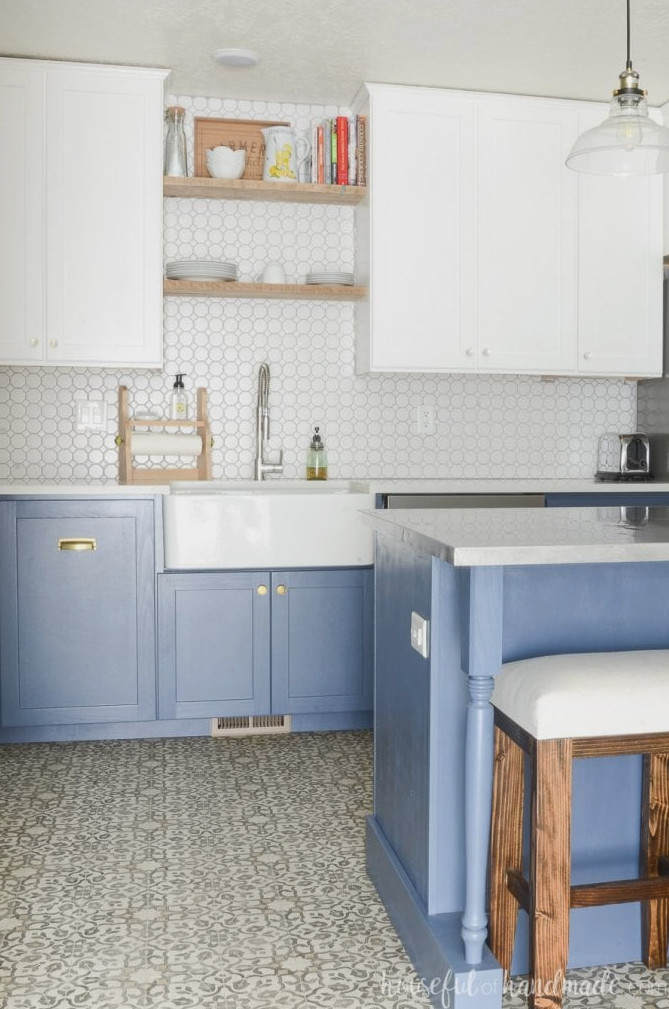 Lovely DIY farmhouse kitchen featuring blue and white cabinets with a spacious farmhouse kitchen sink.