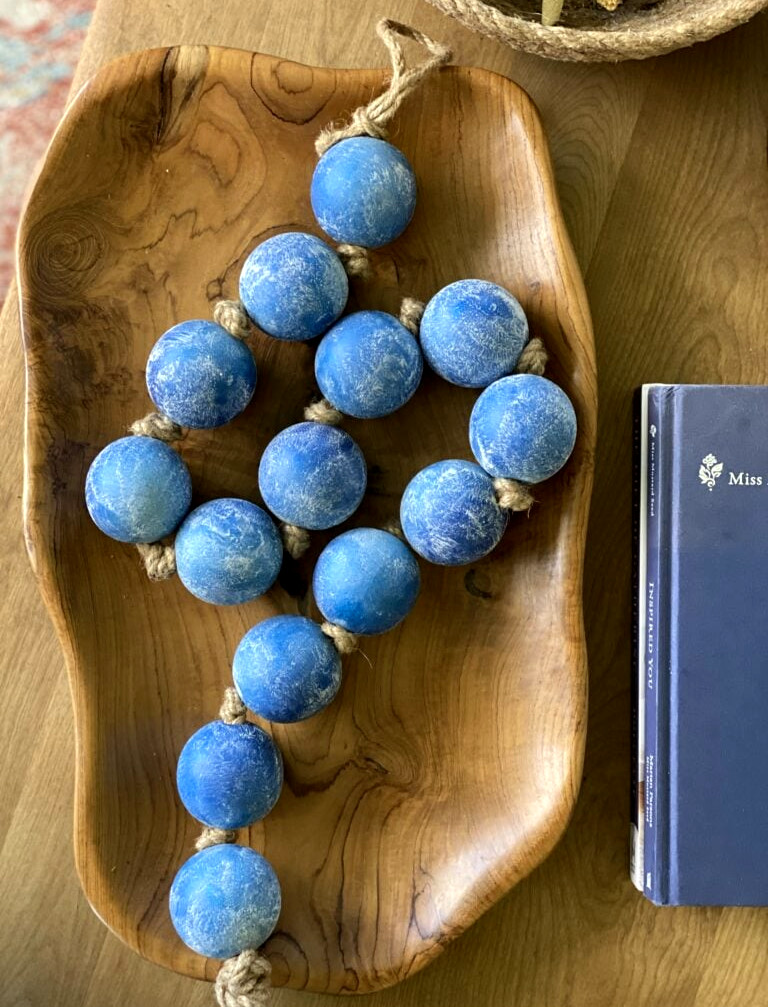blue beads in a wood dish