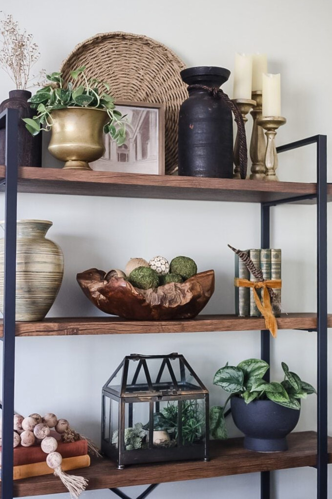 bookcase arranged with antique and thrifted decor