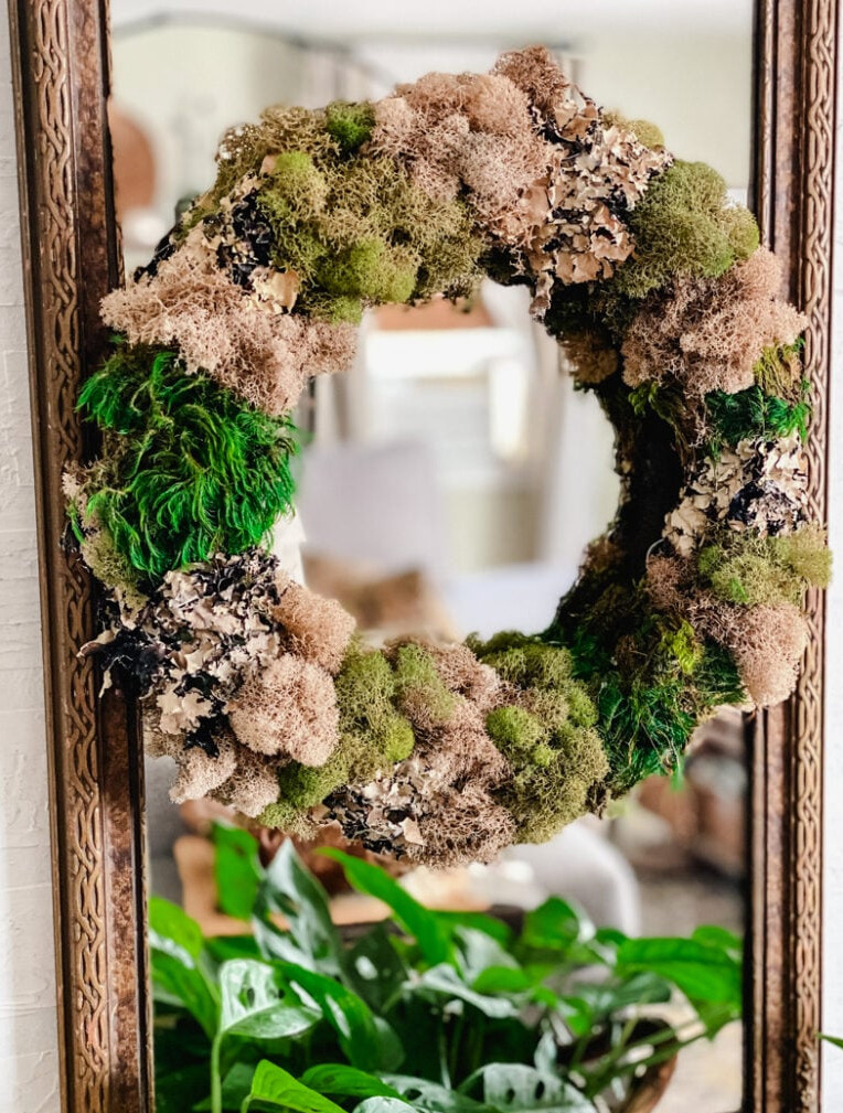 moss wreath hanging on a mirror