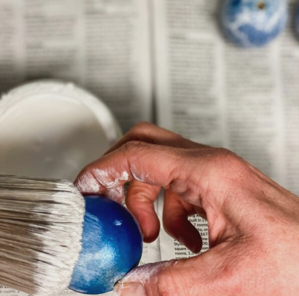 a hand and a paintbrush