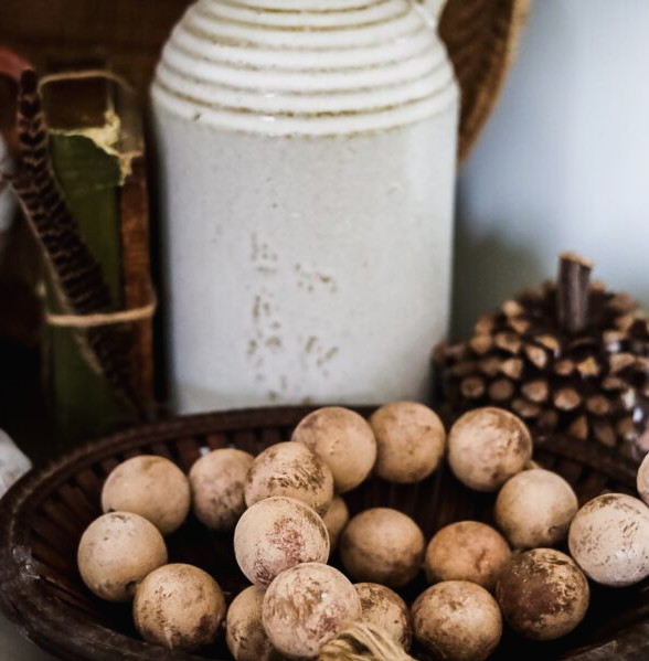basket of beads, white jug and pumpkin