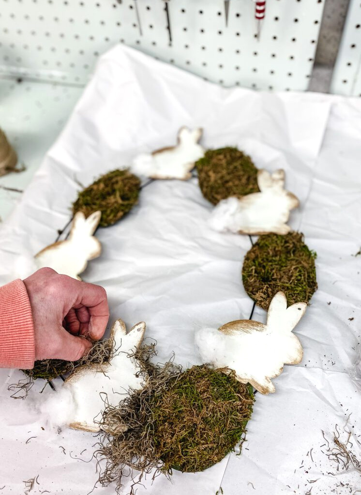 adding Spanish moss to an Easter wreath
