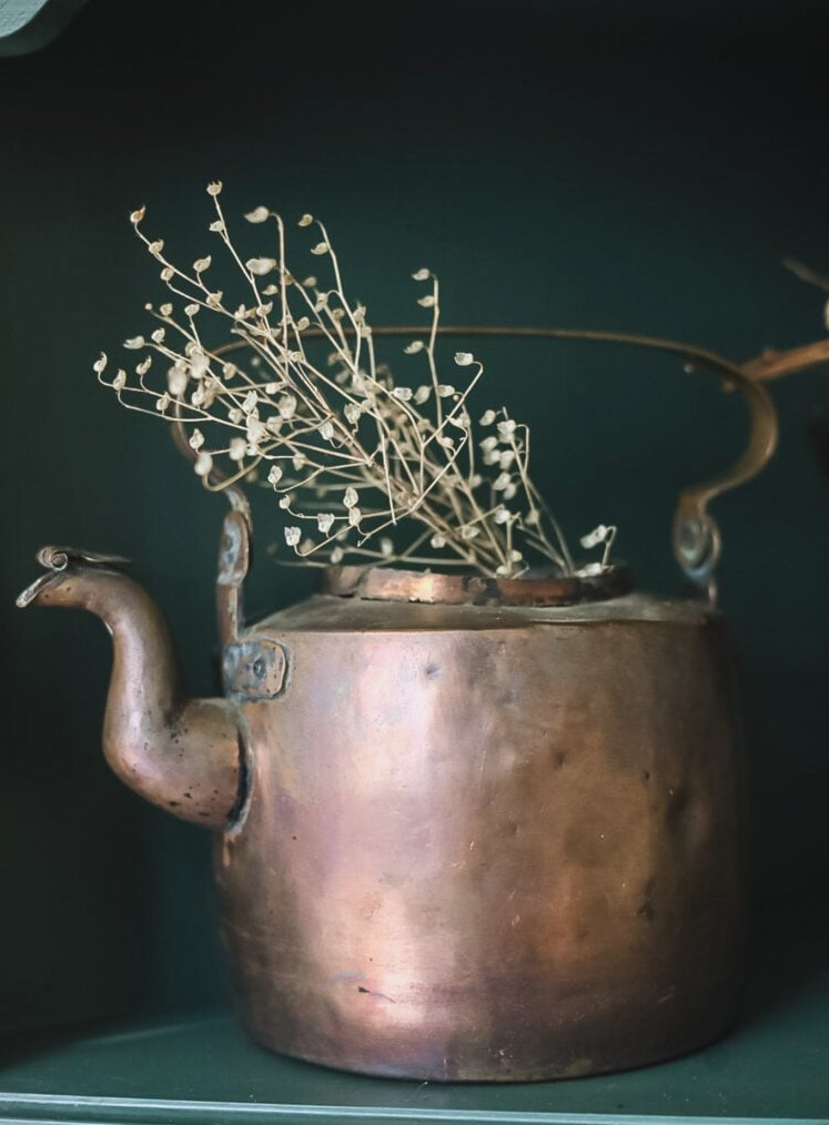 copper kettle with dried blossoms