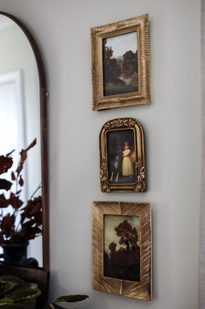 3 gold frames hanging on wall