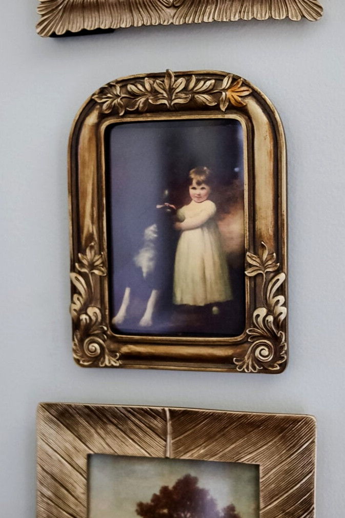 vintage looking framed portrait of a little girl and dog
