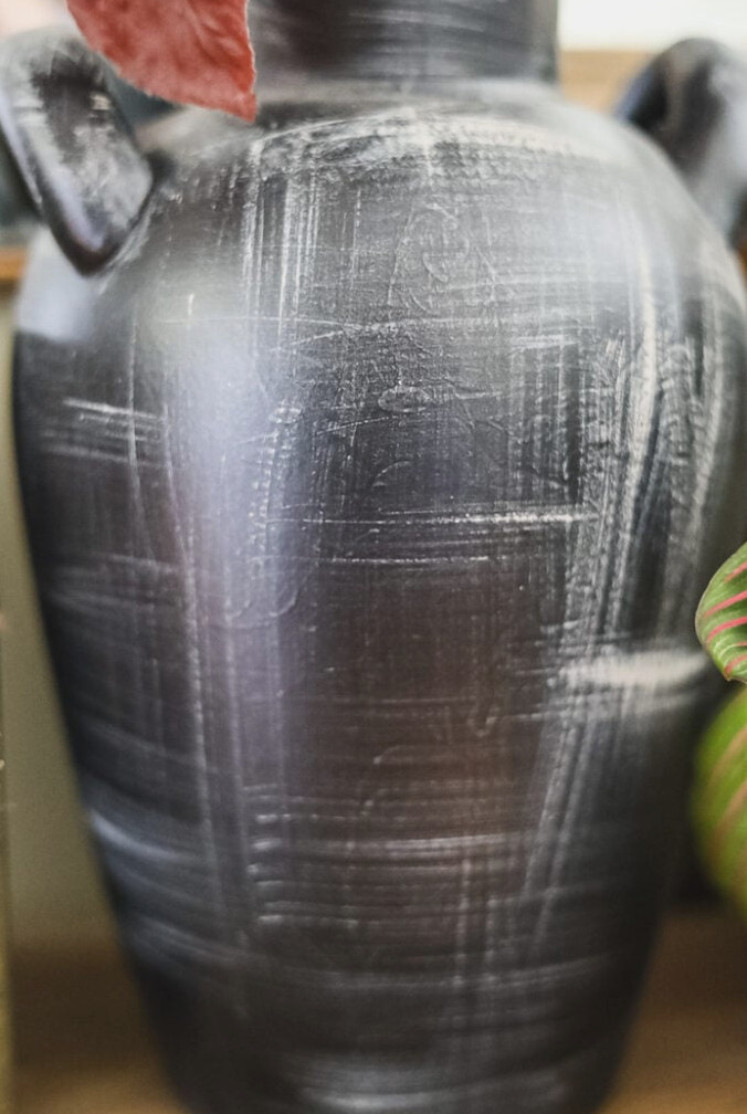 close-up of detail on a black-painted upcycled thrift store vase
