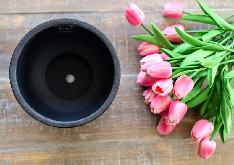 black planter and pink tulips