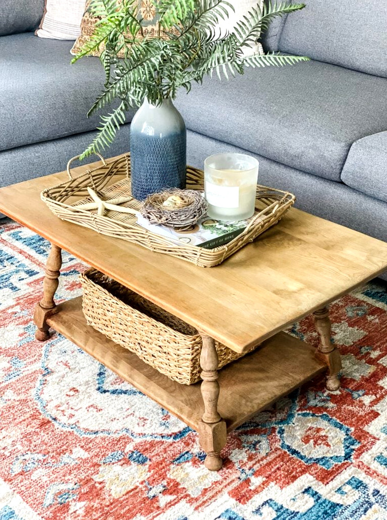 coffe table on a blue and rust rug