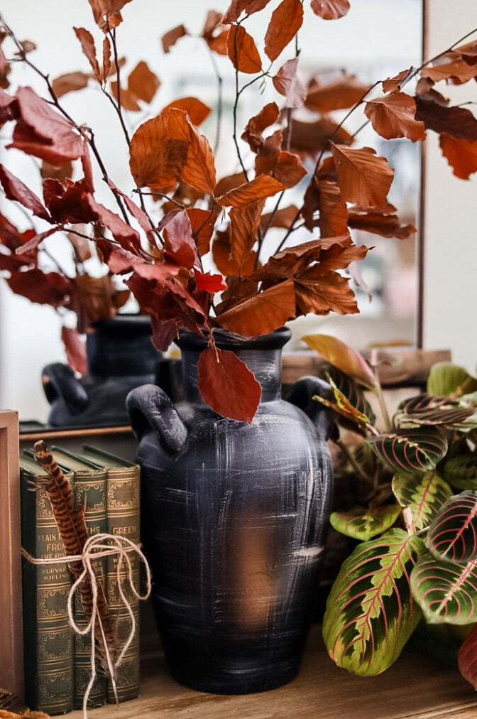dried leaf stems in black vase