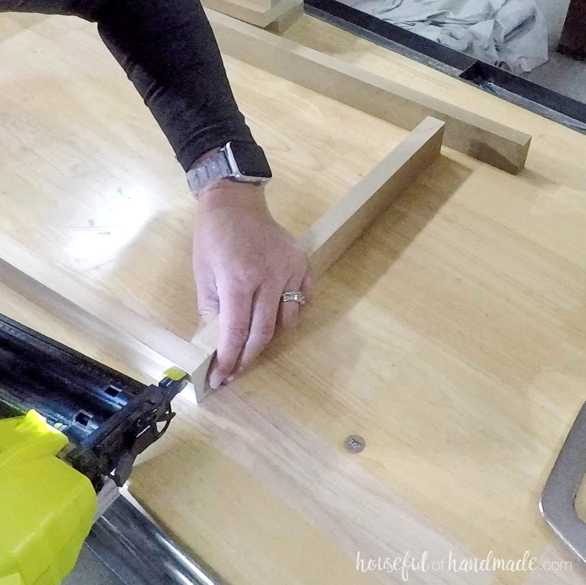 Nailing 1x2 boards together for the slatted shelf sides. 
