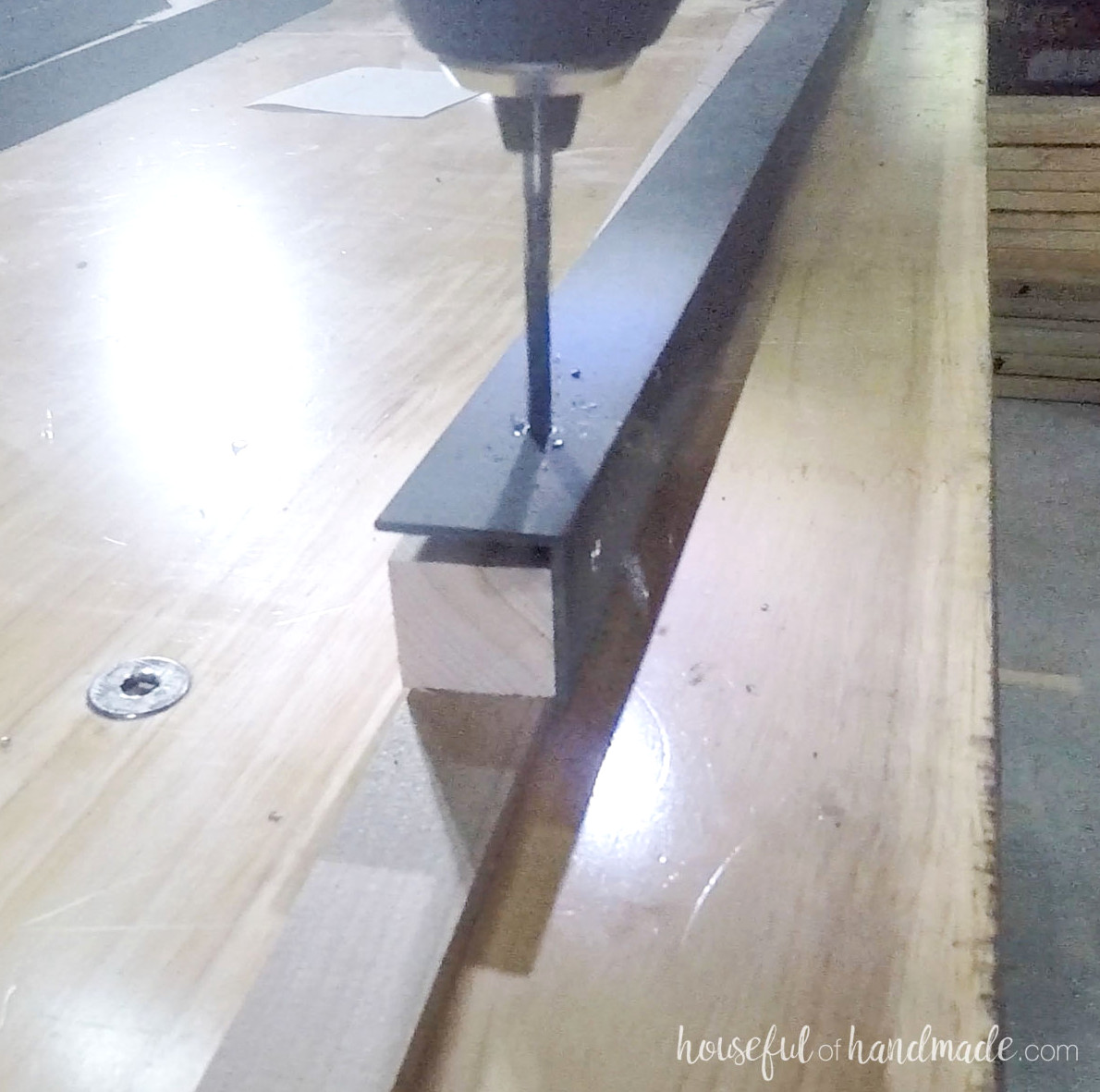 Drilling a hole in the angle iron.