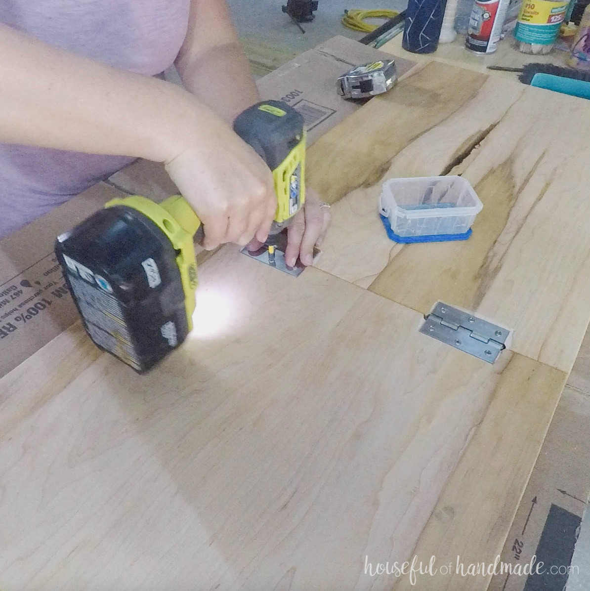 Attaching hinges to the underside of the top. 