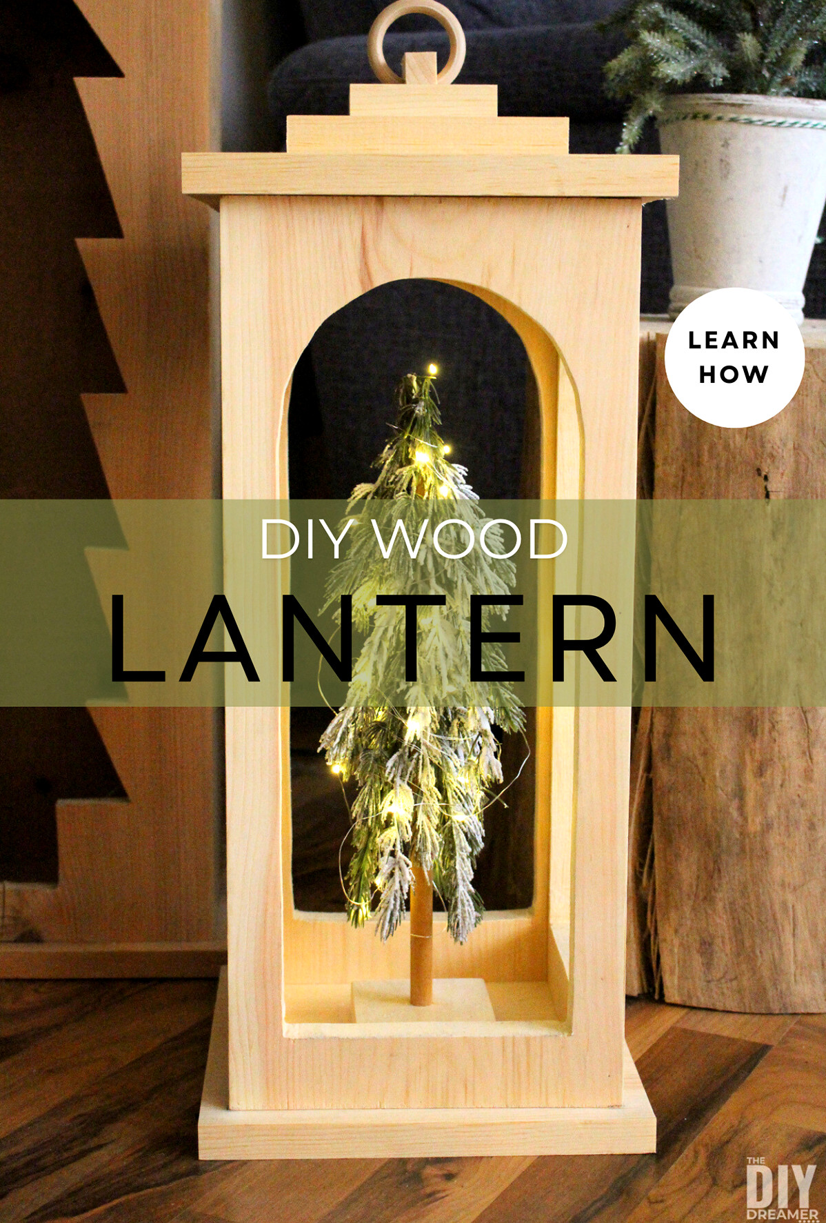 DIY Wood Lantern with a small Christmas tree with lights inside.