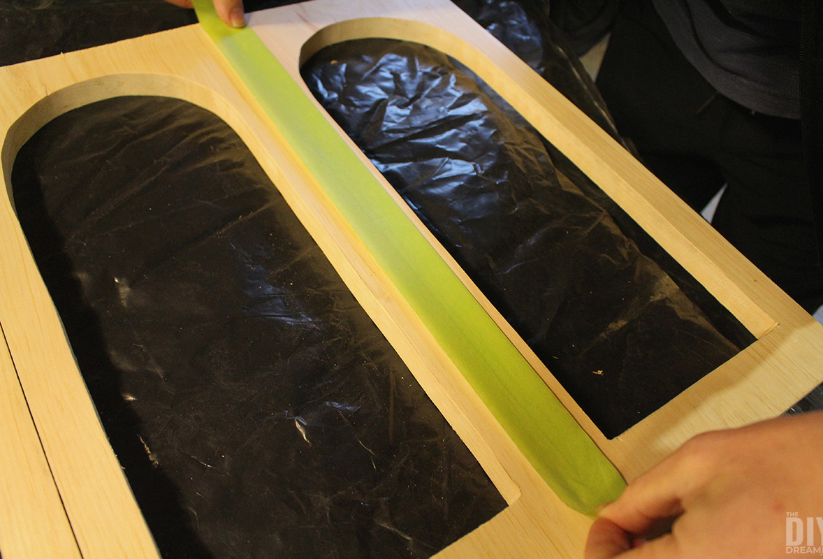 Placing masking tape along the edges.