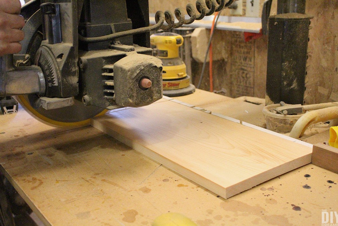 Miter saw cutting pine boards.