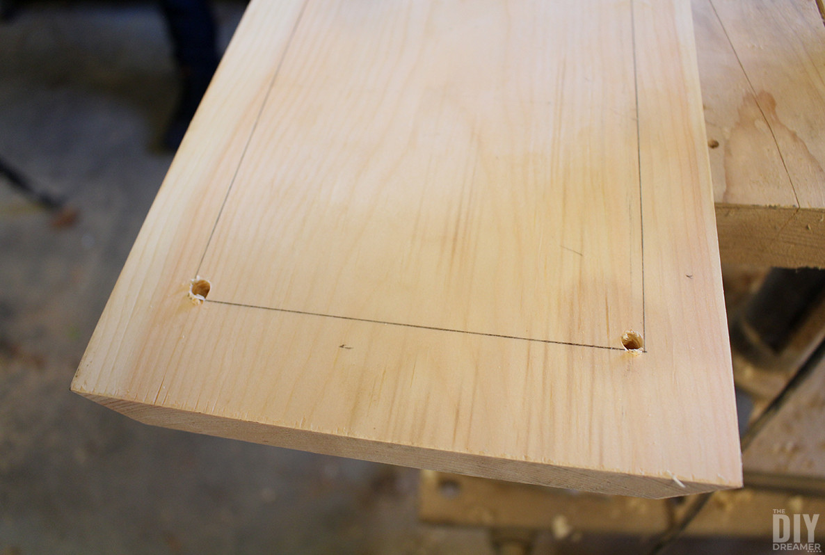 Wood with two holes in the corners of template.