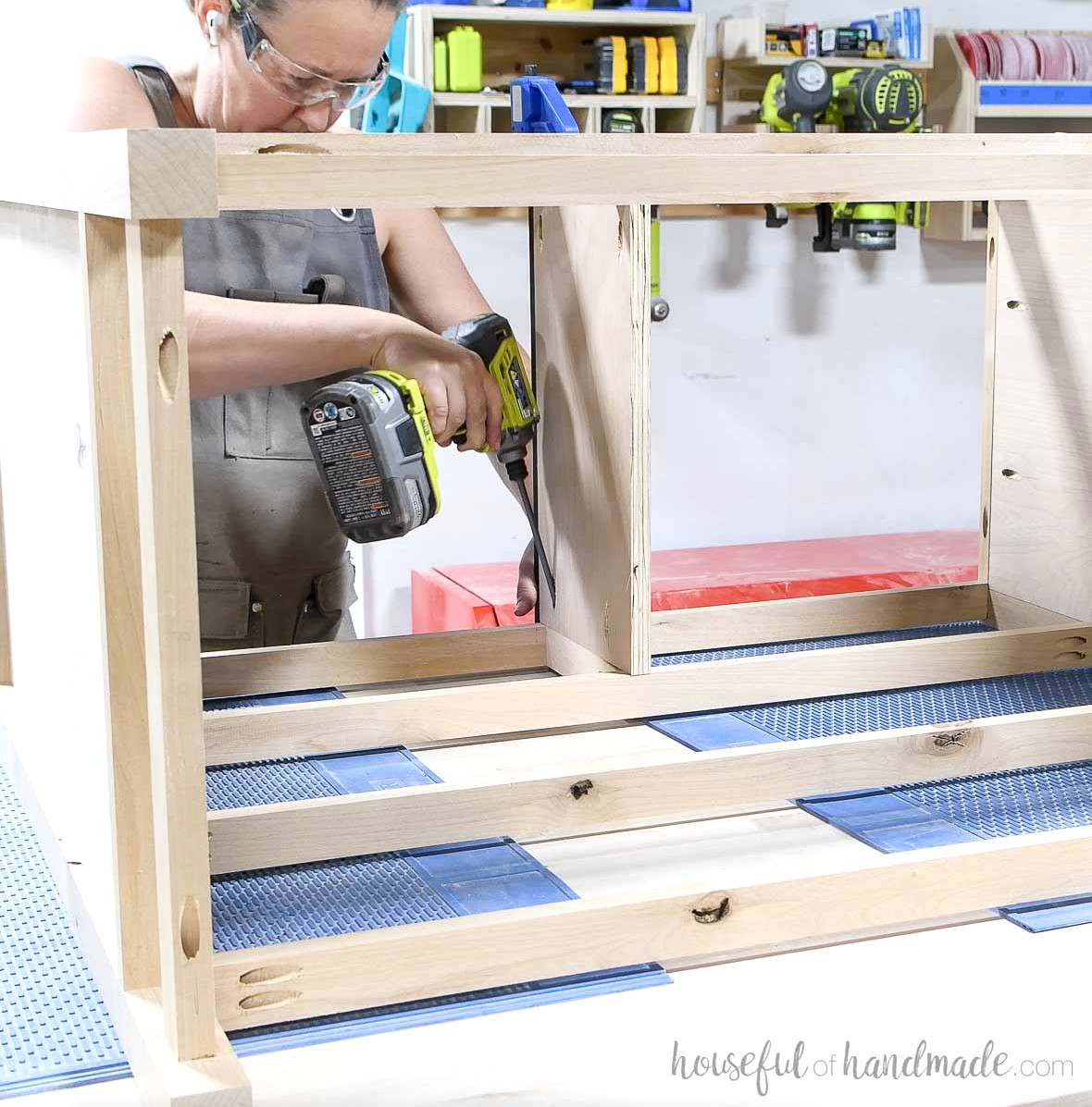 Attaching a plywood panel to the center top of the dresser frame.
