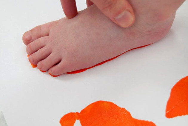 Pressing foot into orange paint