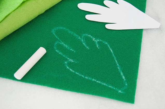 Outlining template on green felt