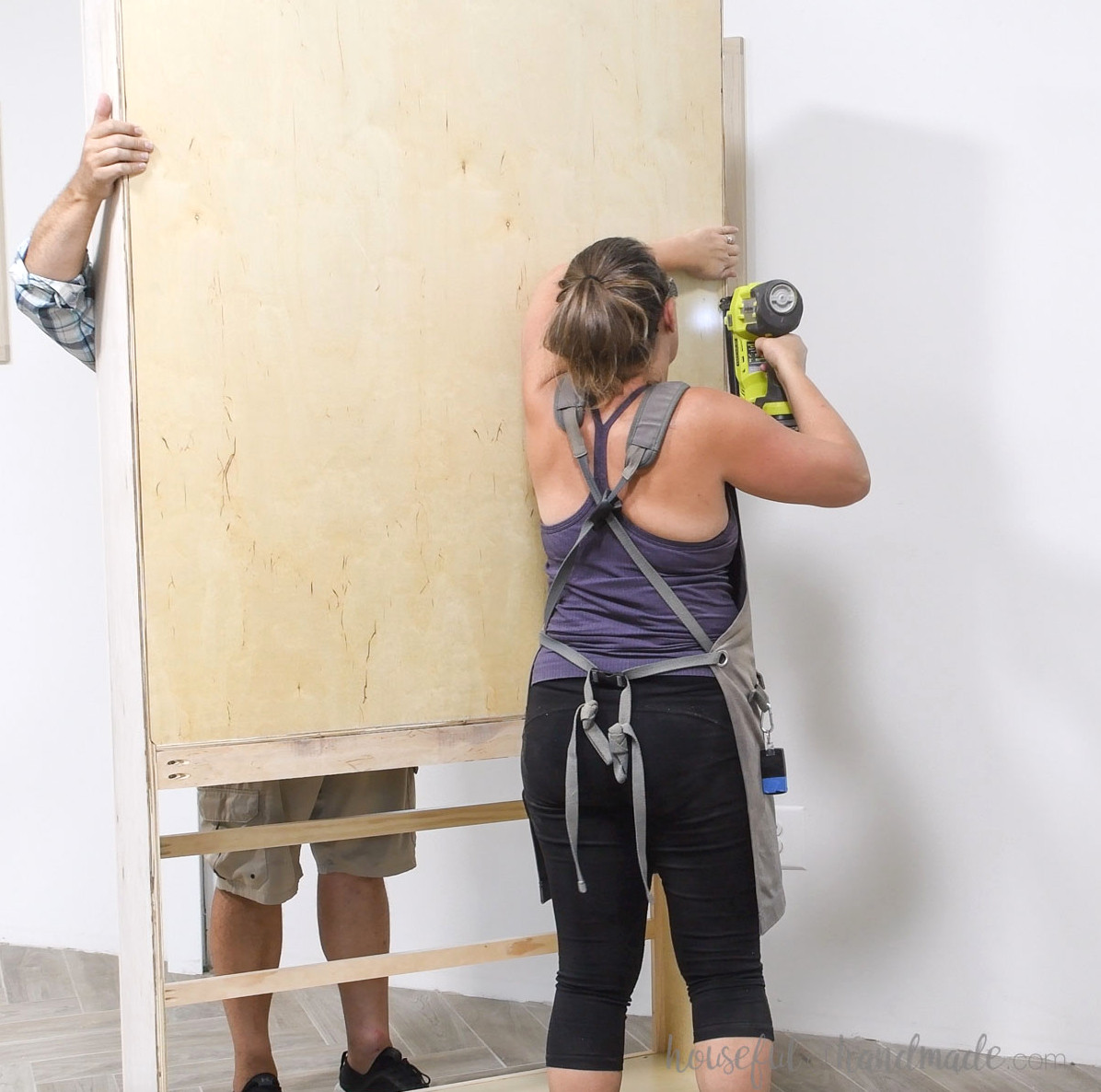 Securing the back to the tall bookcase with brad nails. 