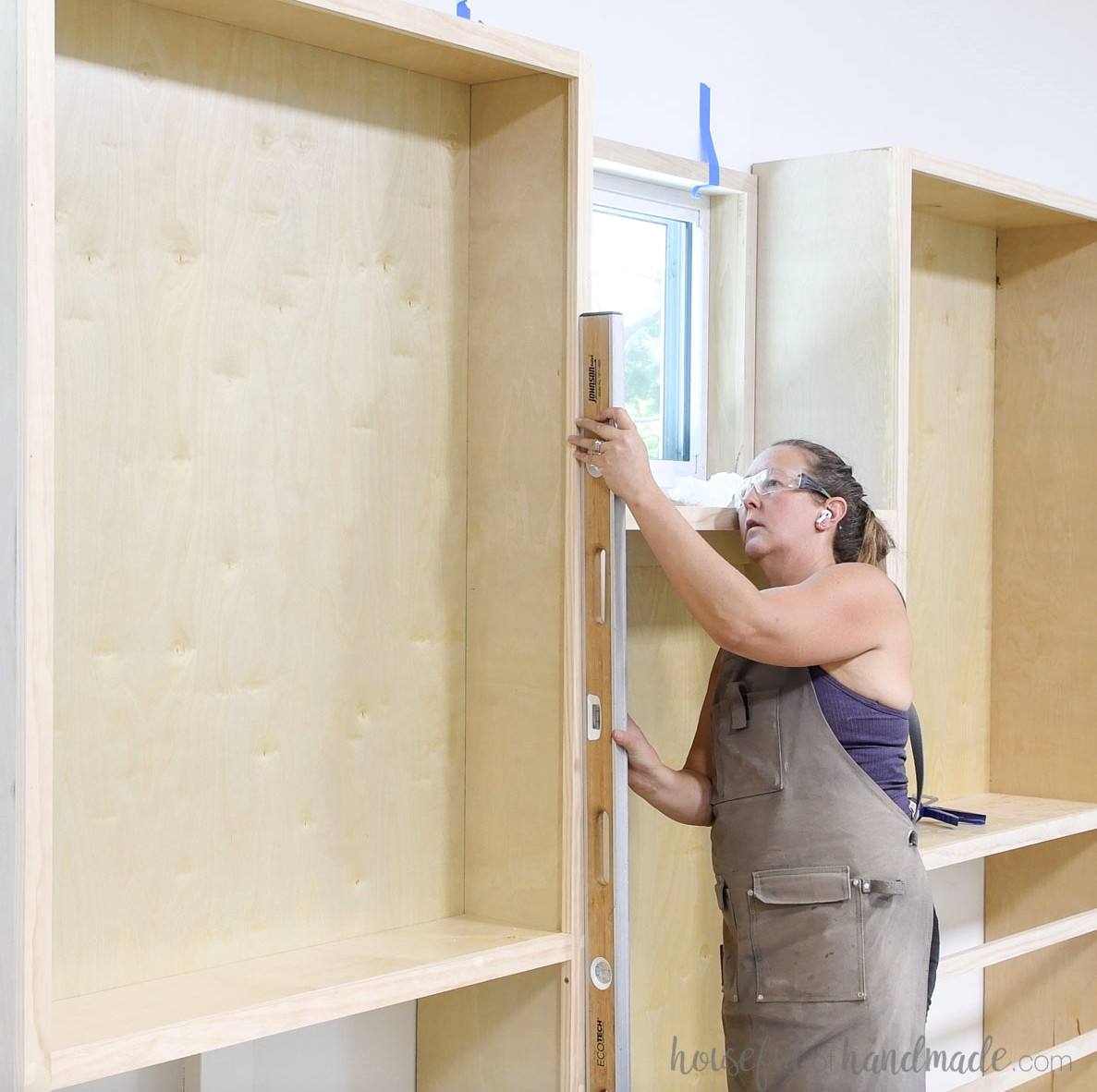 Checking whether the bookcases are plumb. 