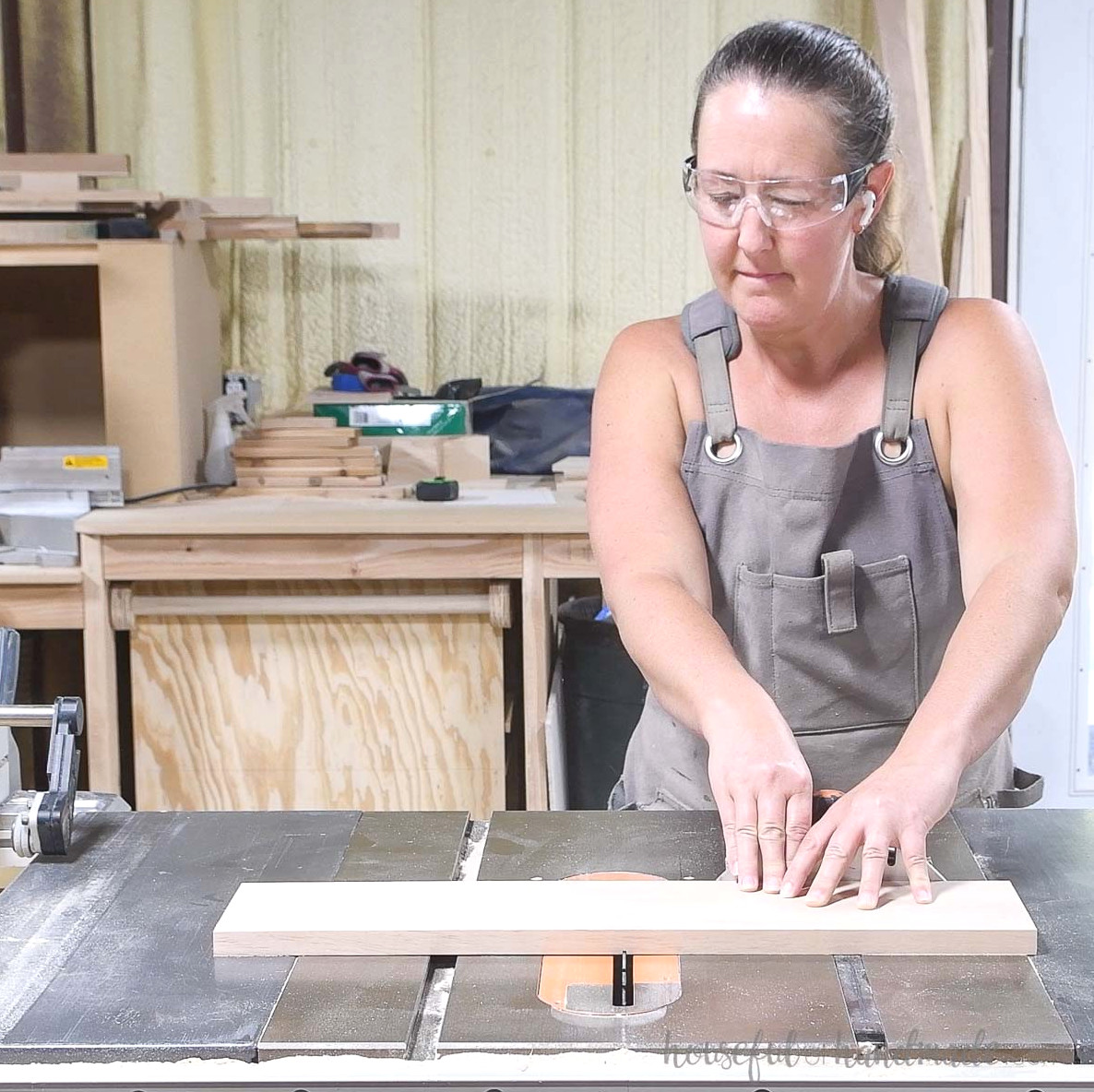 Cutting a narrow groove through the middle of the drawer front piece.
