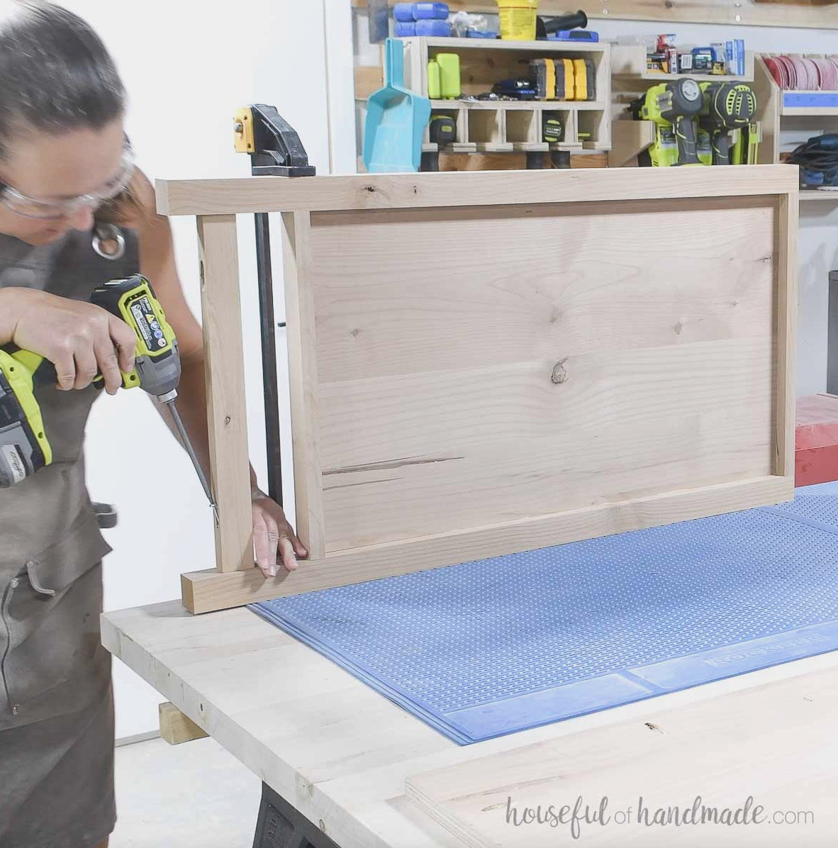 Attaching the second leg to the side of the dresser.