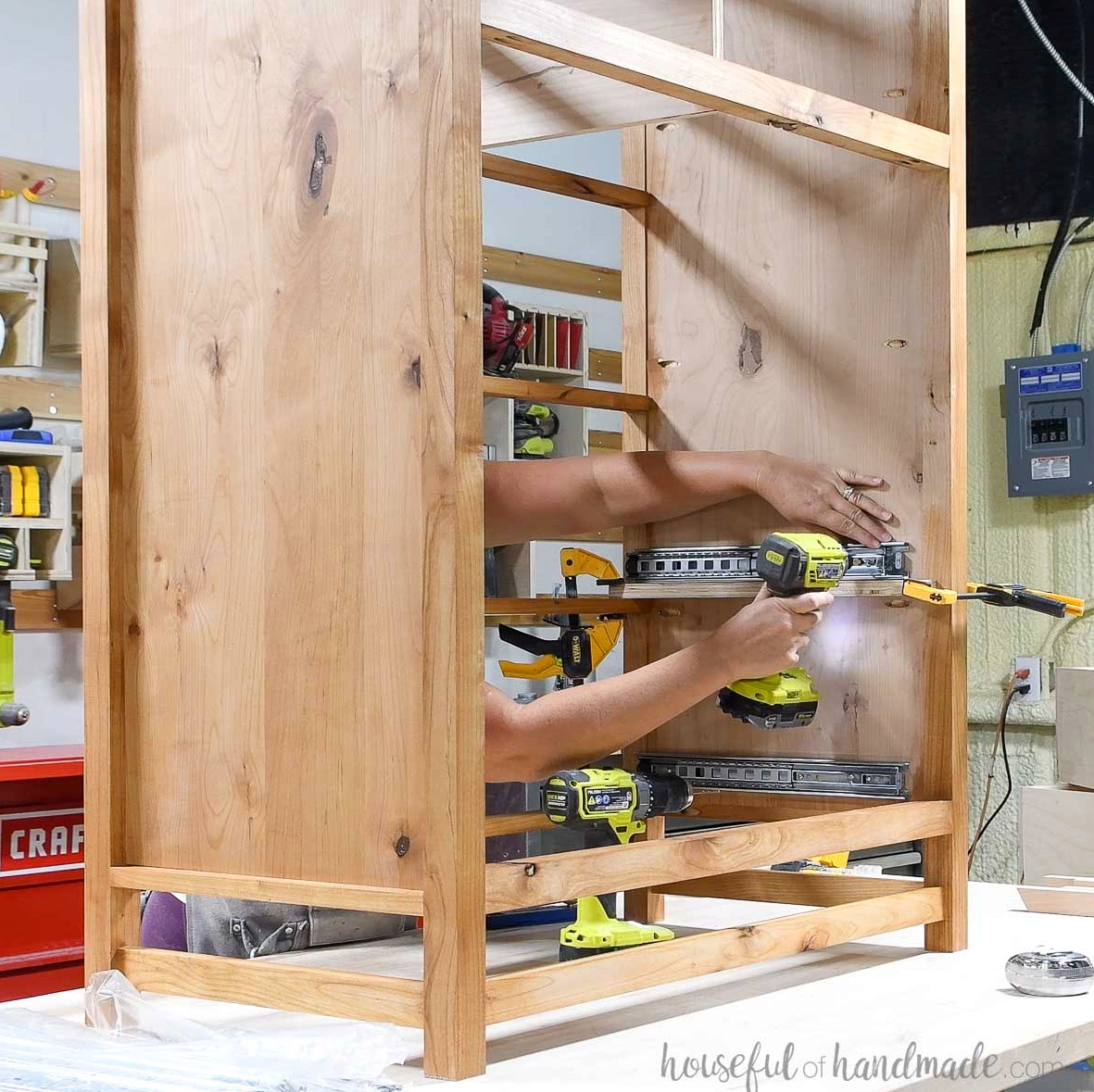Installing drawer slides in the side of the dresser frame.