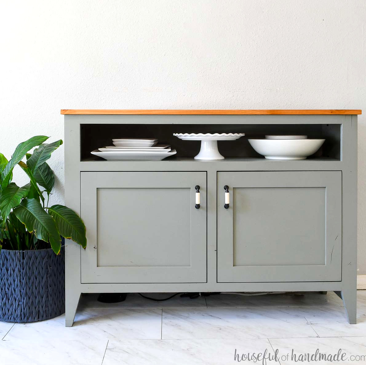 DIY sideboard table featuring two lower doors and an open upper shelf for serving dishes. 