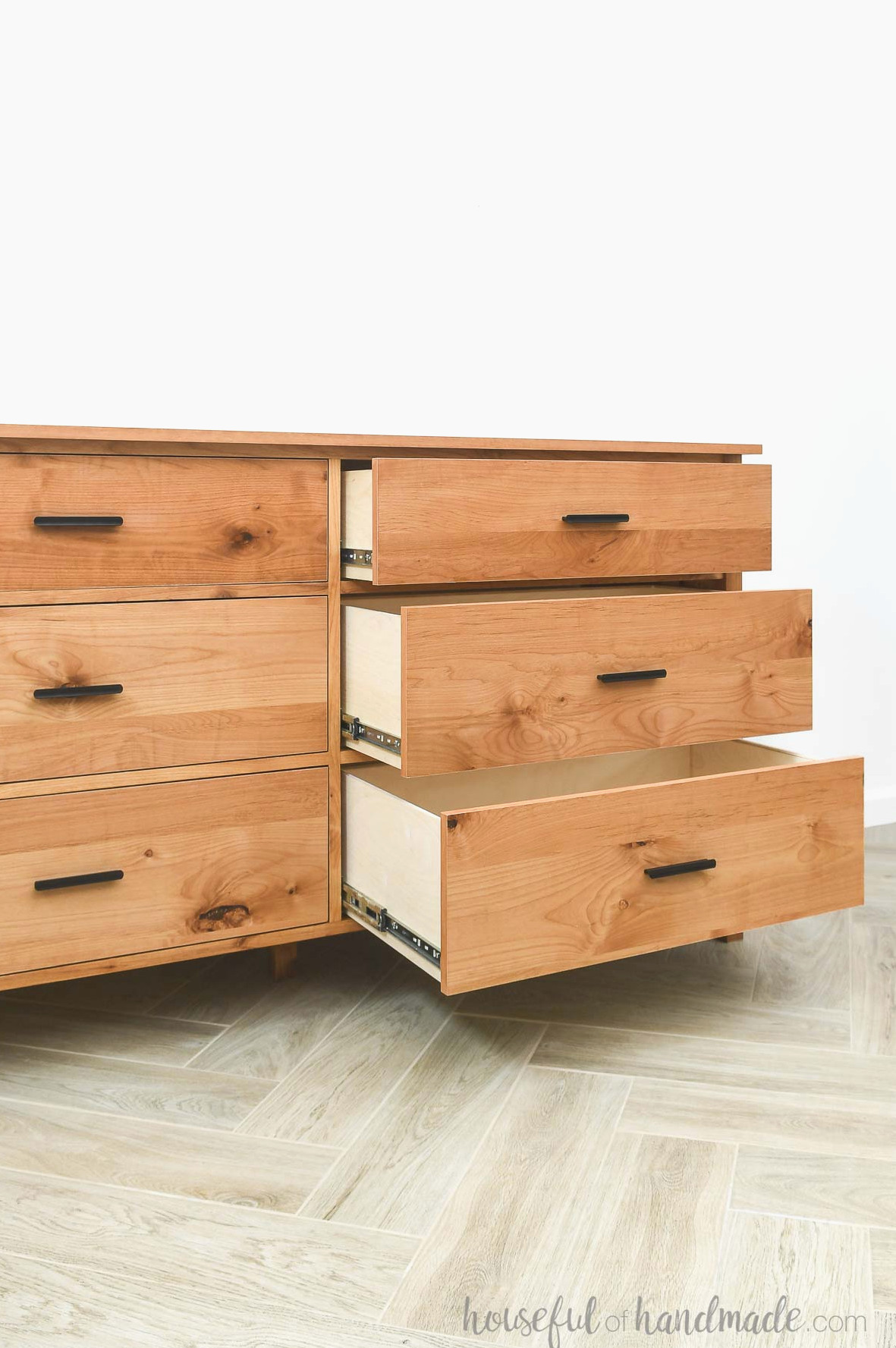 Six drawer dresser with three drawers on one side opened to display the spacious drawer boxes.