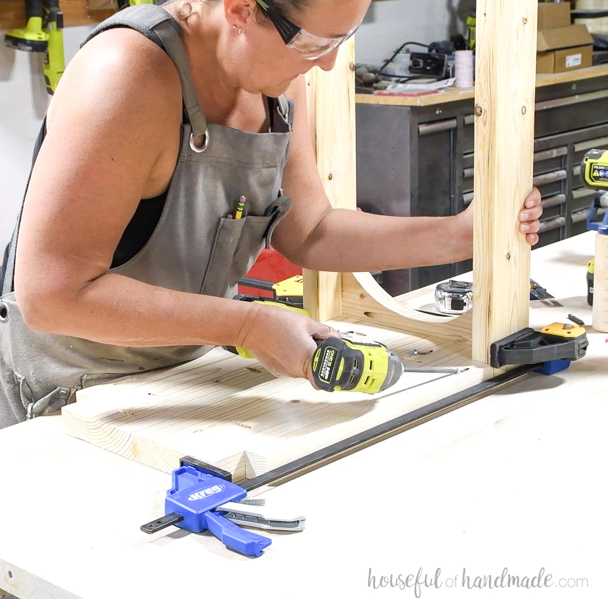 Installing the top between the legs. 