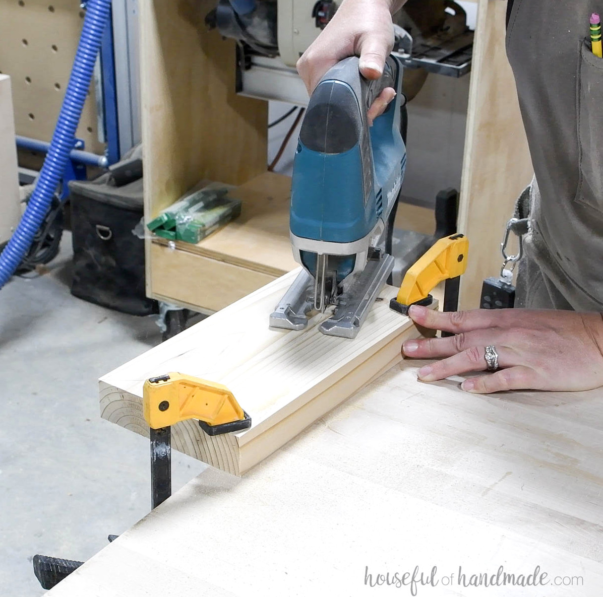Using a jig saw to cut the 2x6 board. 
